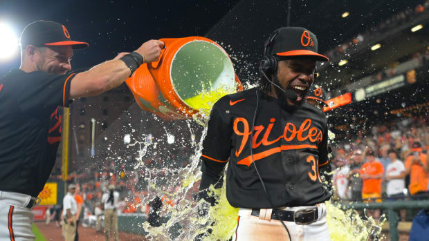 May 12, 2023; Baltimore, Maryland, USA; Baltimore Orioles center fielder Cedric Mullins (31) reacts after first baseman Ryan O'Hearn (32) and left fielder Austin Hays (21) dump Gatorade on him during a post game interview against the Pittsburgh Pirates at Oriole Park at Camden Yards.